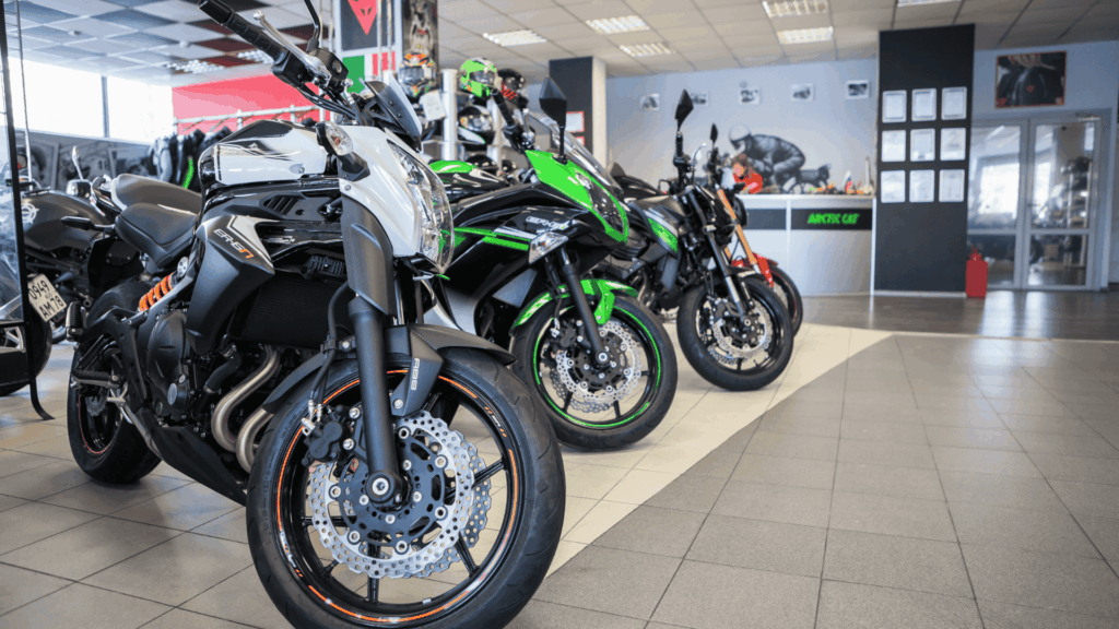A photo taken inside a motorcycle dealerships, displaying several motorcycles for sale.
