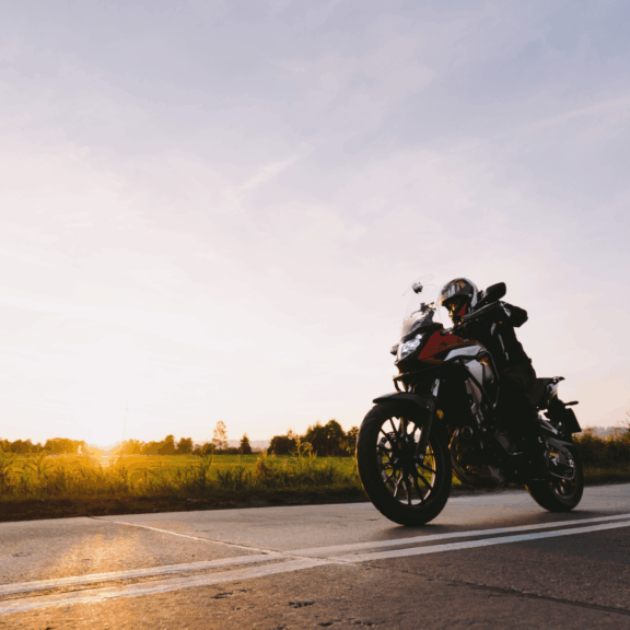 motorcycle on road with winter sunset